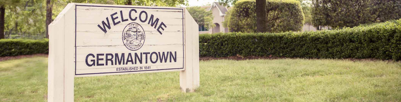 A white wooden sign that reads "Welcome to Germantown"