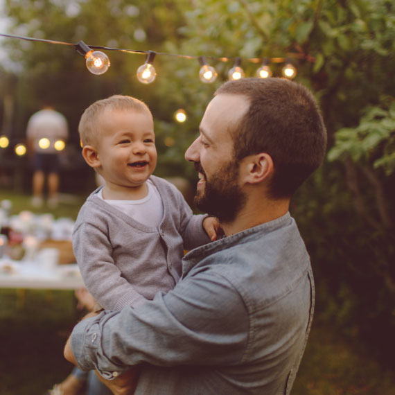 a man holding his child while laughing