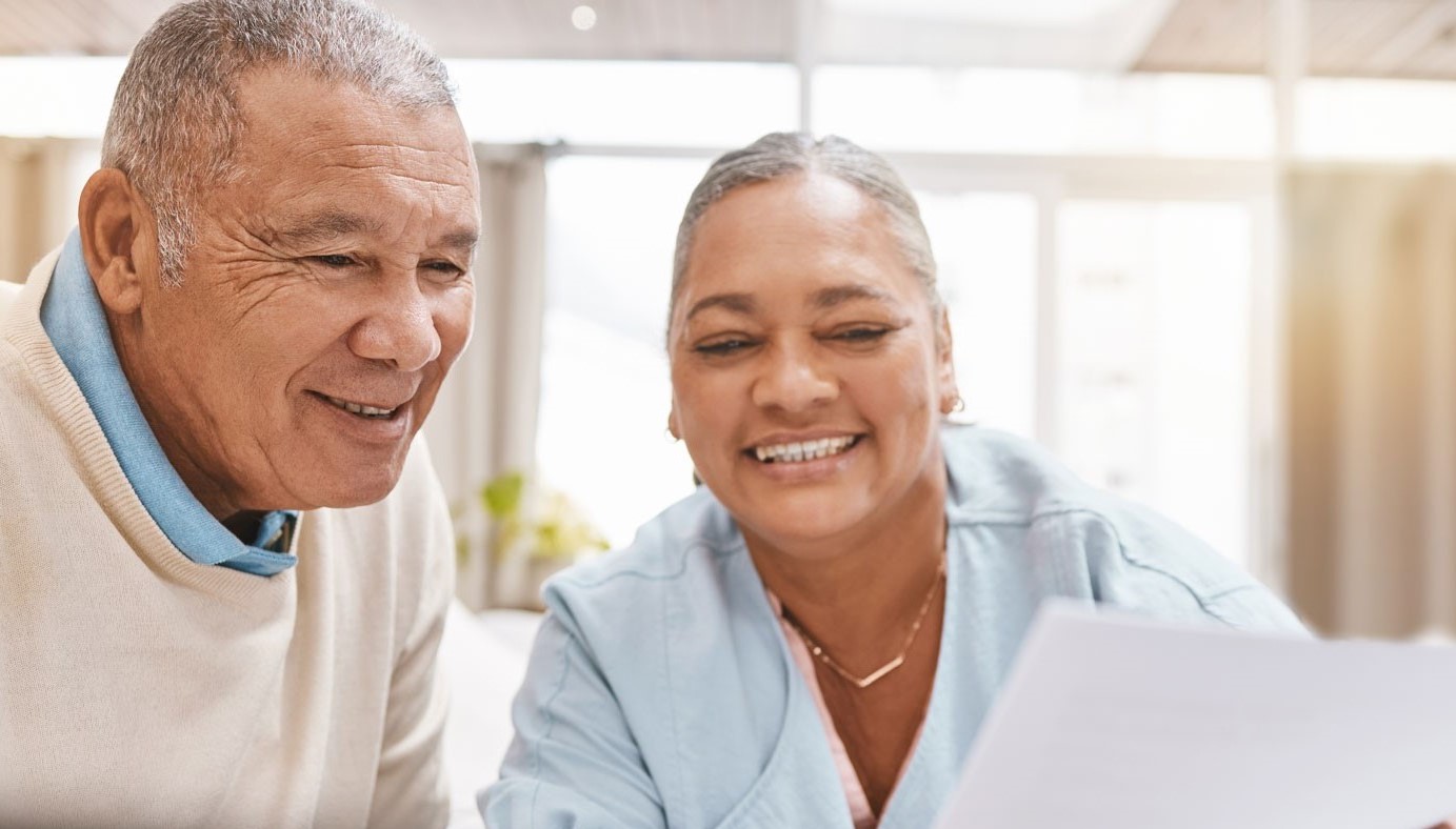 man and woman looking at paper